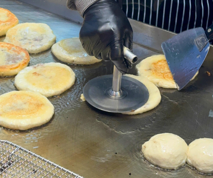 hotteok korean sweet pancake being grilled at street stall